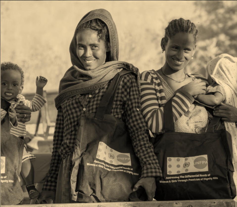 Women carrying dignity kits